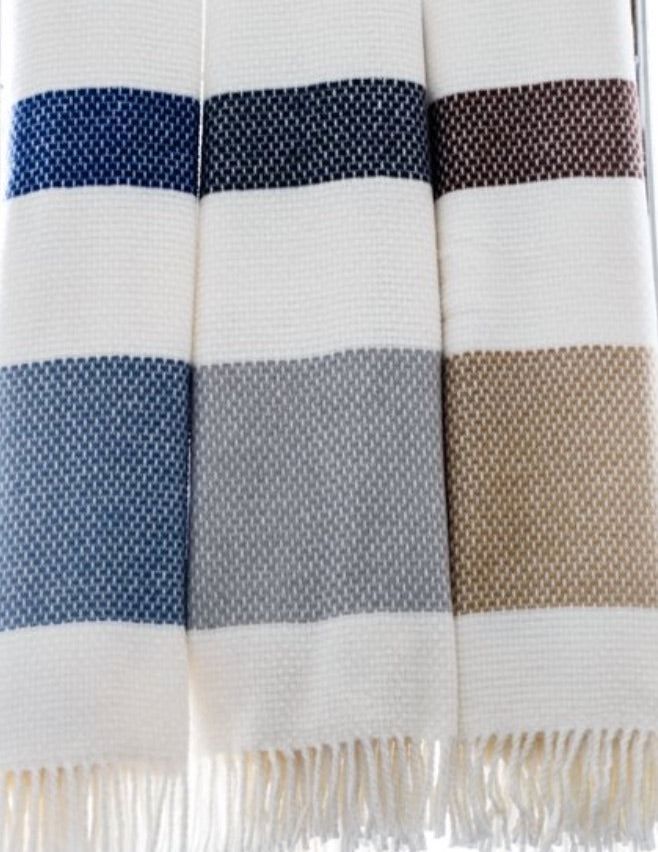 Four A Soft Idea Personalized Throw Blankets hang side by side, each with thick blue, dark brown, gray, and beige stripes on white and fringed edges—perfect custom throws to add a unique touch to your space.