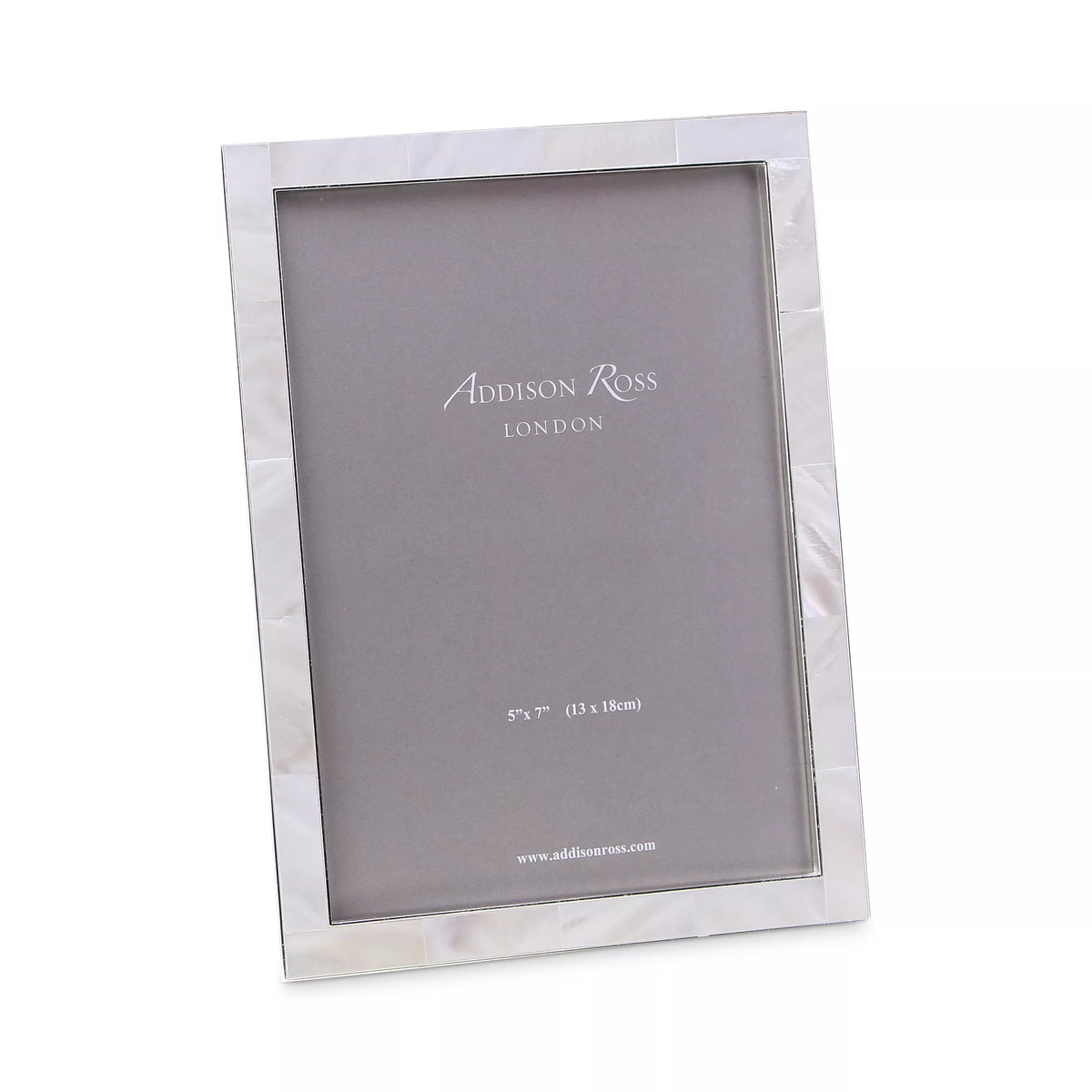 The Addison Ross Mother of Pearl Frame features a sleek rectangular design with a lustrous shell border, shown angled with a grey insert marked for 5x7 (13x18cm) photos—an elegant gift from Addison Ross.