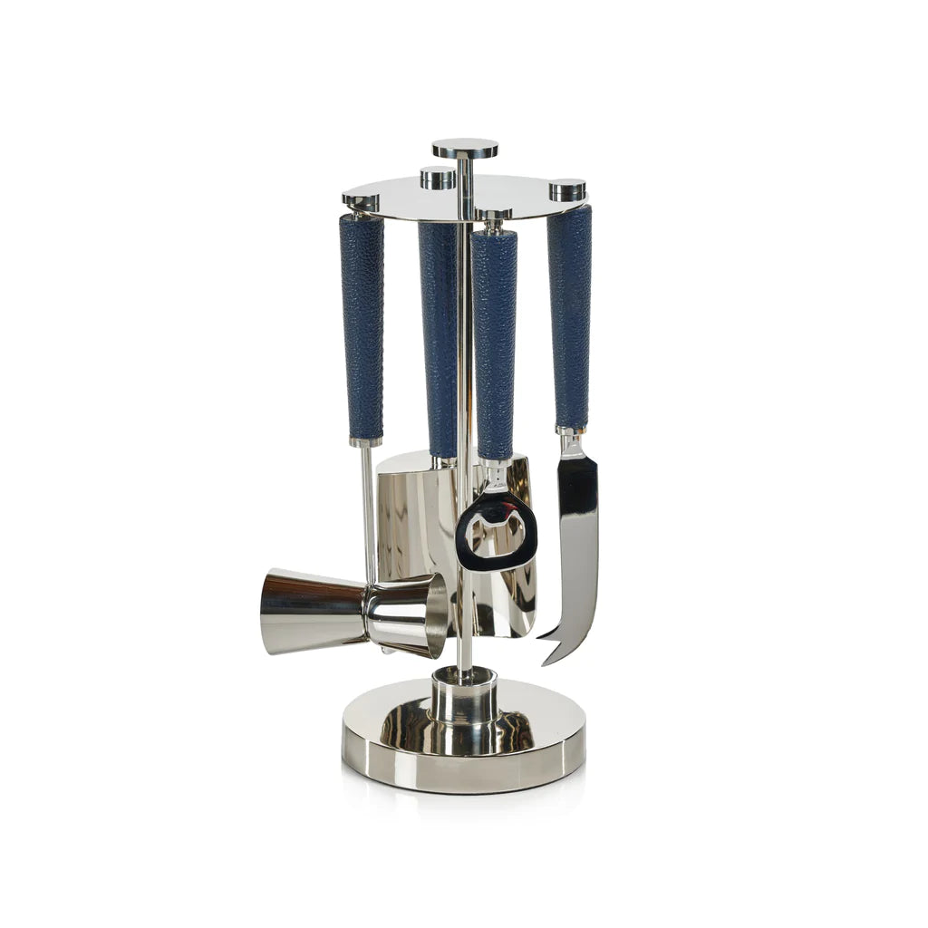 The Zodax Laguna Tool Bar Set features stainless steel tools with blue handles, including a jigger, bottle opener, knife, and more on a sleek circular stand—ideal for stylish nickel bar accessory seekers.