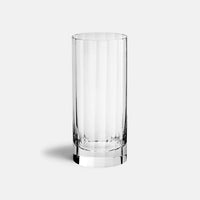 The Richard Brendon Fluted Highball stands upright, empty and clear, on a plain light gray background, showcasing the glass's elegant craftsmanship.