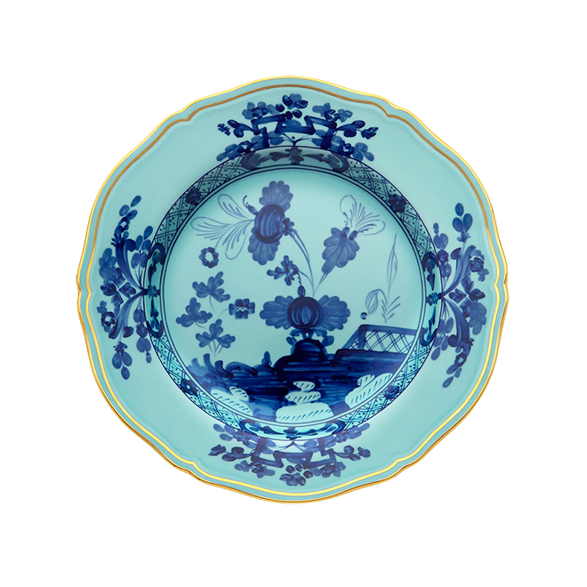 The Ginori 1735 Oriente Italiano Dinnerware Iris plate features a blue and white chinoiserie floral motif with a gold rim on a white background.