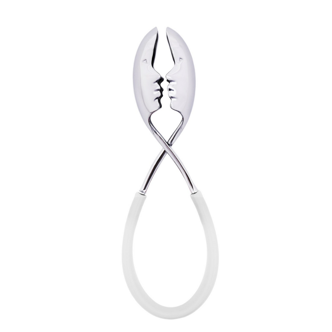 Add a playful touch to summer entertaining with the KISS Salad Tong by Casa Bugatti—silver tongs featuring faces that “kiss” when closed and elegant oval-shaped white handles, perfect for your next gathering.