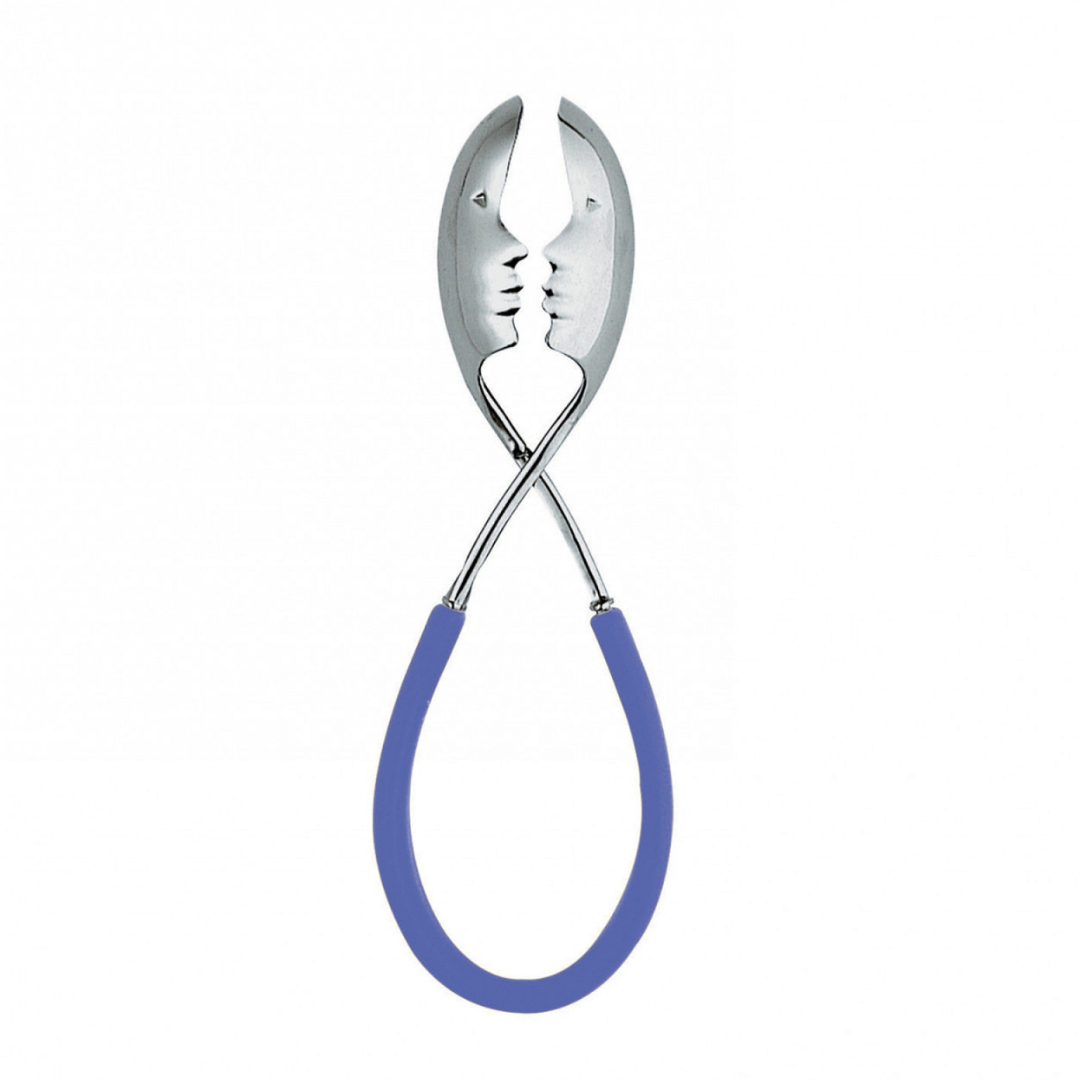 The Casa Bugatti KISS Salad Tong features two metal tongs with face cutouts and blue rubber handles crossed to look like faces about to kiss—a playful accessory perfect for summer entertaining.