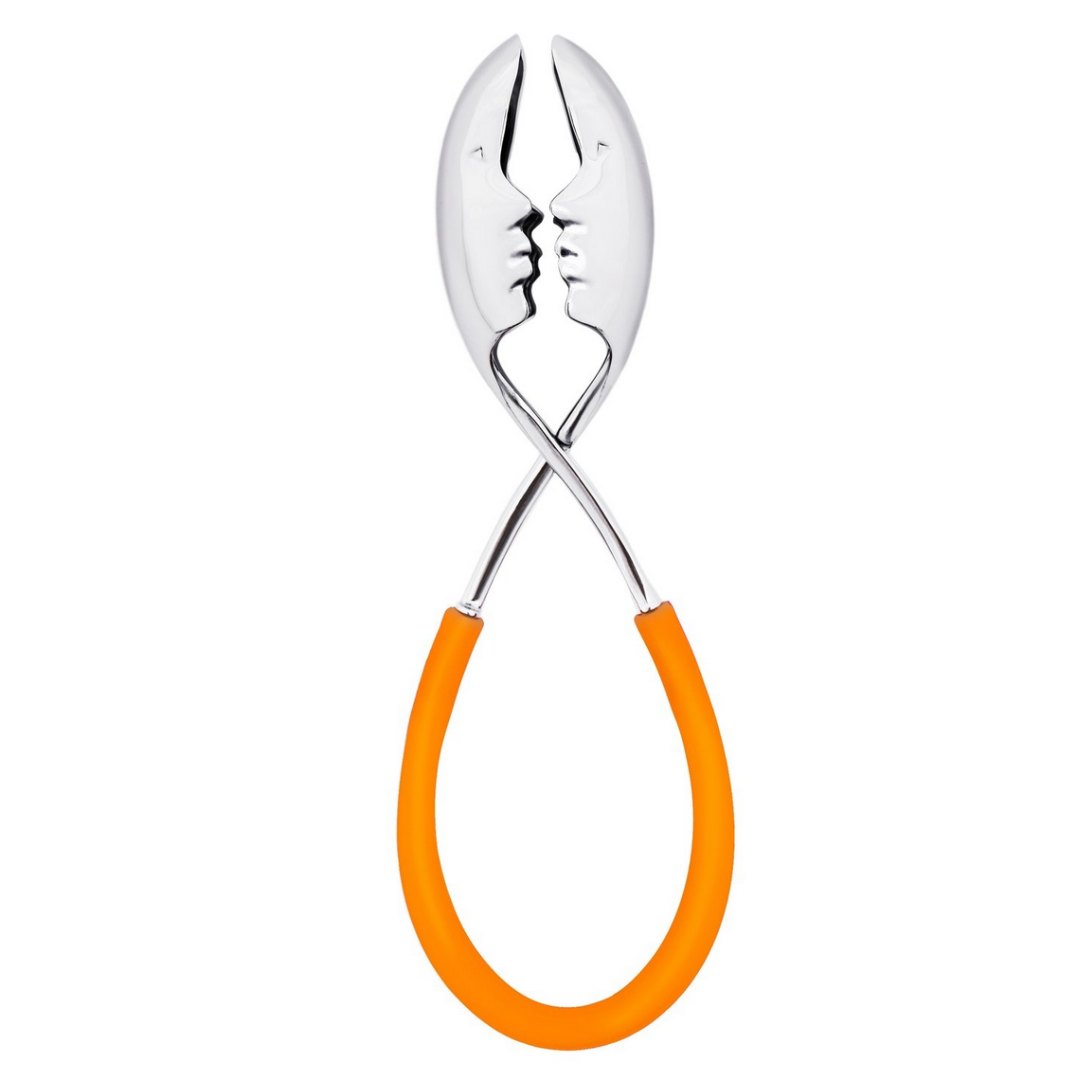 The Casa Bugatti KISS Salad Tong features two silver faces in profile, about to kiss, with orange rubber-coated crossed handles—a charming table accessory perfect for summer entertaining.