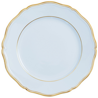 A white porcelain plate with a scalloped edge and thin gold rim, viewed from above on a plain background—part of the Raynaud Mazurka Gold & Blue Grey Dinnerware collection.