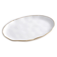 The Moonlight Oval Tray by PAMPA BAY is a white porcelain platter with an uneven wavy edge and a slim gold titanium rim, shown on a plain white background.