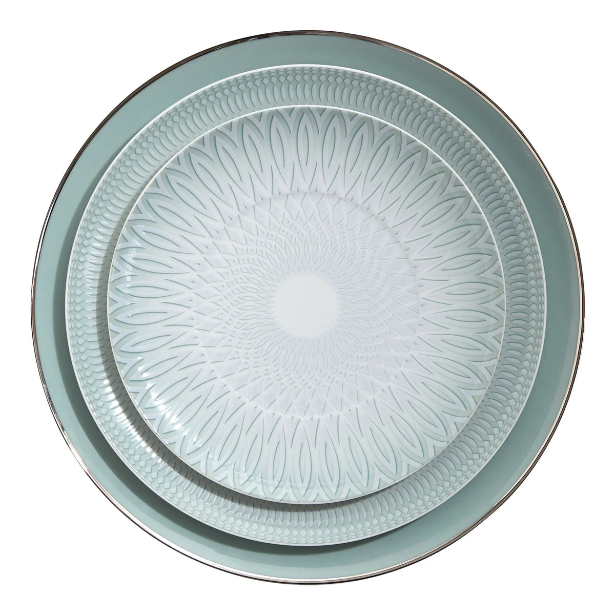 Two round plates from the Vista Alegre Venezia Dinnerware collection nest together: the smaller plate features a geometric design, while the larger showcases a solid rim with a metallic edge, all in light blue-green porcelain.