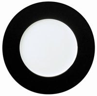 The Philippe Deshoulieres Seychelles Black Charger 12.6" is a round white porcelain plate with a wide, textured black rim, shown from above on a plain background.