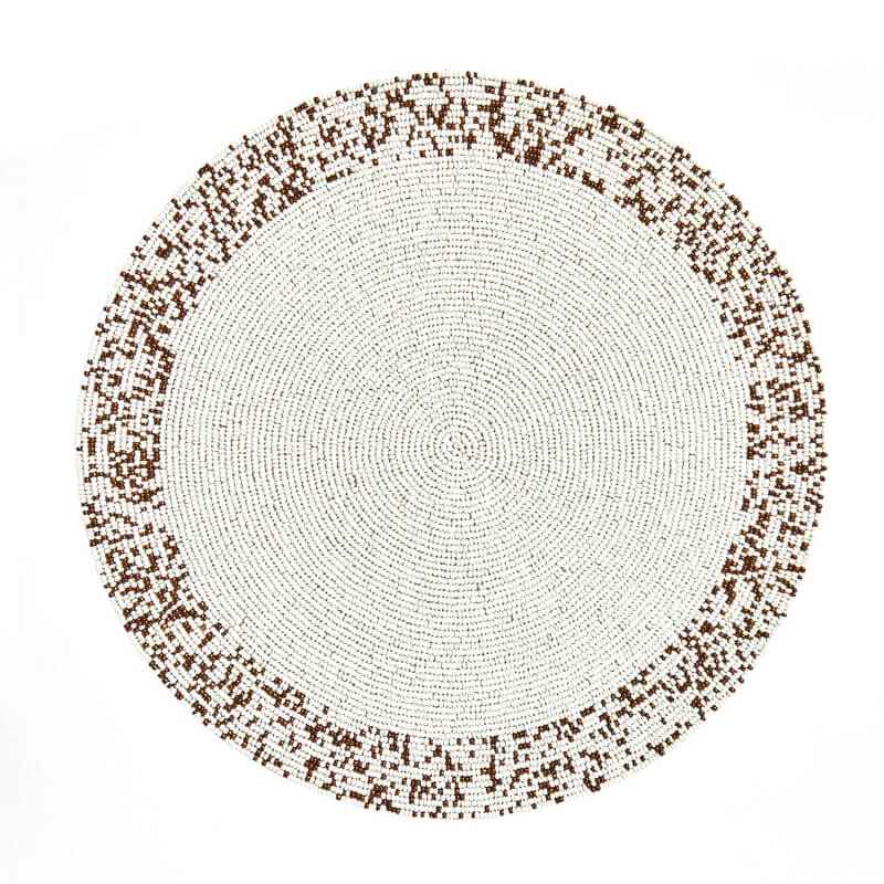 The Splatter Beaded Placemat Set of 4 by Von Gern Home features round placemats with a white center and a pixelated brown and white beaded border—an elegant decorative table mat set, shown on a white background.