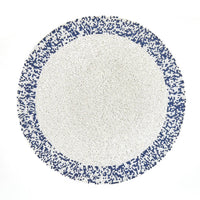 The Von Gern Home Splatter Beaded Placemat Set of 4 features round mats with a white center and pixelated blue-and-white beaded border, adding stylish decorative flair to your table.