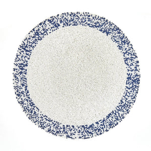 The Von Gern Home Splatter Beaded Placemat Set of 4 features round mats with a white center and pixelated blue-and-white beaded border, adding stylish decorative flair to your table.