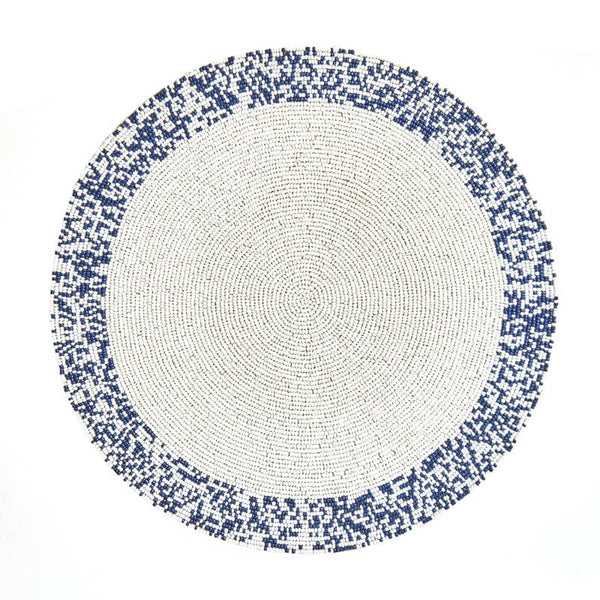 The Von Gern Home Splatter Beaded Placemat Set of 4 features round mats with a white center and pixelated blue-and-white beaded border, adding stylish decorative flair to your table.