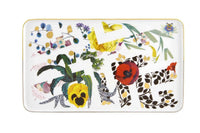 The Vista Alegre Primavera Serving Pieces, rectangular with gold trim and colorful floral, leafy designs, pair beautifully with dessert plates. "LOVE" is boldly spelled out in leafy letters among flowers and abstract dots.