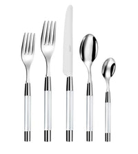 The Capdeco Zoe Flatware 5 Piece Setting - Clear, made in France, features stainless steel forks, knife, tablespoon, and teaspoon with shiny metallic heads and elegant clear handles with silver accents.